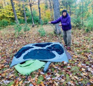 Hiker packing up a tent